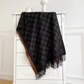 Detail view of double-sided jacquard scarf with tassels and geometric patterns - Black Coffee