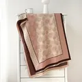 Close-up of vintage floral polka dot winter shawl scarf with detailed fringe edges - Pink