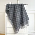 Detailed view of grey cashmere-feel scarf with jacquard floral pattern and soft tassels - Gray