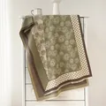 Close-up of vintage polka dot and camellia floral scarf with delicate short tassels - Green
