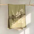 Detail of sage green winter scarf with traditional lotus print and fringe edges - Green