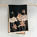 Close-up of the elegant lotus pattern and delicate white fringes on black winter scarf - Black