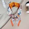 Detail of double-sided paisley and leopard print silk twilly scarf on beige blazer - Orange and White Paisley Leopard Style (PD2517-2)