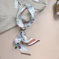 Detail of 120cm printed silk scarf tied on handle with retro abstract face pattern - Vintage Light Blue Portrait Style (PD2522-3) / 120x5cm