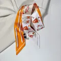 Orange and ivory printed silk scarf with classic buckle patterns on beige suit background - Letter H and Harness Pattern / Orange