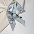 Modern printed silk twilly scarf with blue cartoon patterns on a beige blazer jacket - Fun Cartoon Illustration / Gray