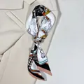 Elegant floral chain print twilly scarf styled on a white blazer for fashion accessories - White Orange Black Equestrian Style (PD2536—3)