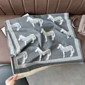 Detail of gray zebra pattern scarf with fine off-white fringes on leather background - Zebra Gray