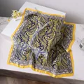 Navy and yellow paisley silk square scarf displayed on marble with floral accents - Blue Yellow Vintage Print Style / Blue