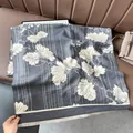 Detailed view of gray-blue cashmere-feel scarf with white leaf print and fine tassels - Leaf Pattern Gray