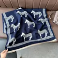 Detail of navy blue zebra pattern scarf with soft cream tassels on a leather background - Zebra Blue