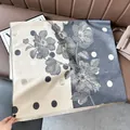 Detailed view of color-block scarf with retro floral pattern and fringe edge - Color Block Polka Dot Gray