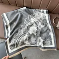 Detail of dark grey cashmere shawl showing large daisy jacquard patterns and tassels - Court Flower Gray