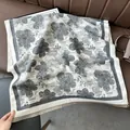 Detail of luxury faux cashmere shawl featuring gray floral jacquard and delicate fringe - Pear Flower Gray