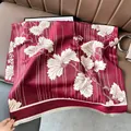 Detail of burgundy pashmina with white floral patterns and soft fringe tassels - Leaf Pattern Red