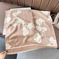 Close-up of elegant gingko leaf patterns and soft fringes on a cashmere-like winter scarf - Leaf-Khaki