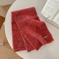 Close-up of red wool blend scarf showing fuzzy texture and brown leather label - 170x26cm / Red