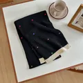 Detail of black knitted wool scarf with colorful polka dots and cream ribbed edge - 155x27cm / Black