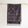 Close-up of bohemian paisley jacquard scarf with ethnic tassels hanging on wood - Black