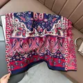 Detail of soft paisley shawl with tassels placed on a leather sofa for an elegant look - Paisley - Blue