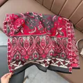 Detail of red and grey paisley cashmere scarf featuring black fringe edges and soft texture - Paisley - Gray