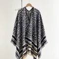 Detail of leopard print knitted shawl featuring striped hem and fringe tassels decoration - Blue