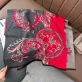 Detail of red and grey paisley wool shawl featuring floral jacquard and fringed edges - Patchwork Paisley - Gray Red