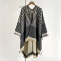 Gray and white cashmere-like hooded poncho featuring geometric H patterns and tassels - Gray / 150x130