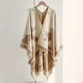 Women's knit poncho cape in beige and coffee cow print pattern with tassel hem - One Size / Khaki