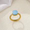 Elegant gold stainless steel ring with a square-cut sky blue stone on white silk - Gold-Blue White