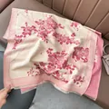 Close-up of pink plum blossom pattern on cashmere feel scarf with tassel and classic border - 180x65cm / Rice Pink