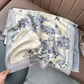 Detail of floral print shawl with fringe edge and retro border pattern on leather background - 180x65cm / Beige Blue