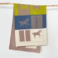 Dettaglio della sciarpa con motivo a cavalli e frange morbide su un ramo di legno - 180x65cm / Grigio