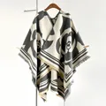 Detailed view of the thick camellia print shawl with fringe hem and striped edging - Gray