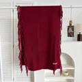 Vue détaillée d'une écharpe bordeaux style cachemire avec texture douce et franges - Rouge Angola