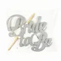 Detail of silver glitter Bride to Be cake topper with sticks in retail packaging - Silver