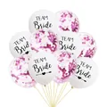 Close-up of white Team Bride balloons and transparent rose gold confetti balloons set - White (Black Text) + Magenta Confetti