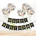Close-up of Happy Birthday banner and multicolored confetti balloons on wooden table - Black Gilded Banner + 5 Colorful Sequin Balloons