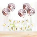 Detail of Happy Birthday gold foil banner and rose gold confetti balloons on a table - White Gilded Banner + 5 Rose Gold Sequin Balloons