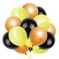 Vibrant yellow orange and black party balloons tied in clusters for construction themes - Excavator Balloons