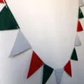 Detail showing the linen texture and stitching of red and green triangular party banners - Linen-Look Paper / Green & Red