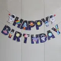 Close-up of Happy Birthday banner with astronaut and planet cards for space themed party - Small Astronaut Birthday Style