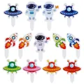 Detail view of astronaut, rocket, and UFO cake toppers for space-themed birthday parties - Astronaut Cake Topper Style
