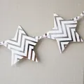 Detail of star-shaped bunting flags with silver wave pattern for party tent decoration - Silver