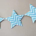 Close-up of blue and white wave pattern star banner with ribbon for party decoration - Blue