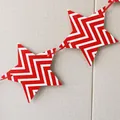 Detail of red and white zigzag patterned star bunting flags with red ribbon for camping - Red