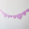 Detalle de guirnaldas de corazones morados brillantes de varios tamaños para decoración - Guirnalda de Corazón Rosa Purpurina