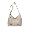 Chique crèmewitte crossbodytas met ritsvakken en hartvormige metalen details - Beige