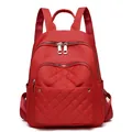 Water-resistant red nylon backpack with quilted diamond pattern and silver zippers - Red