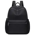 Classic black nylon backpack featuring multi-pocket design and adjustable shoulder straps - Black